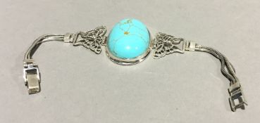 A silver and turquoise bracelet