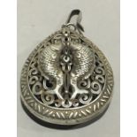A pendant decorated with fish