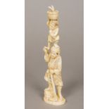 A 19th century Japanese carved ivory okimono Of a woodsman balancing his son on his head.