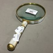 A mother-of-pearl mounted magnifying glass