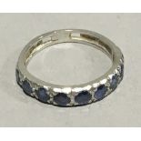 A sapphire set half hoop eternity ring