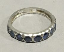 A sapphire set half hoop eternity ring