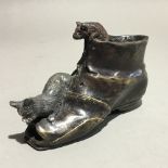 A bronze figure of a cat in boots