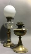 A brass oil lamp, flue and shade,