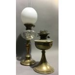 A brass oil lamp, flue and shade,