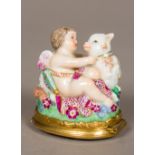 A 19th century Continental porcelain patch box Formed as cupid and a sheep, inscribed A.