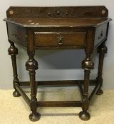 An early 20th century oak single drawer side table