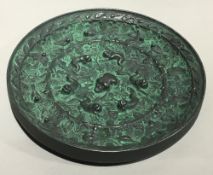 A Chinese cast frog and grape roundel/mirror