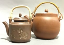 Two terracotta teapots