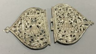 An Indian white metal buckle Worked and pierced with figures. 13 cm wide.