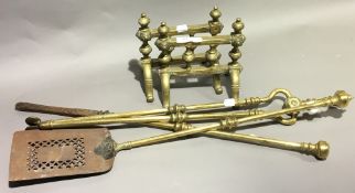 A set of 19th century brass fire irons and a pair of brass fire dogs
