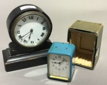 A travelling alarm clock and a small French ebonised bracket clock
