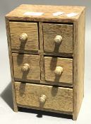 A partridge wood miniature bank of drawers