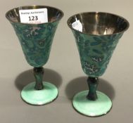 A pair of silver and enamel goblets