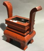 A red painted wooden koro