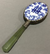 A Chinese blue and white porcelain backed jadeite handled hand mirror