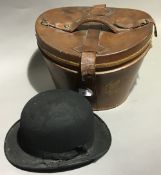 A bowler hat in a leather hat box