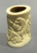 A 19th century Japanese ivory carving depicting a figure and monkeys