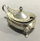 A silver mustard pot