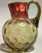 A cranberry and amber glass jug