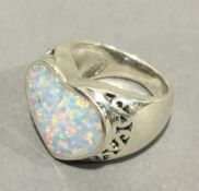 A silver and opal heart ring