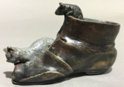 A bronze model of a cat and mouse on a boot