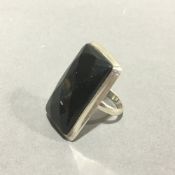 A silver and black stone ring