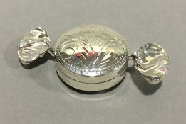 A silver sweet formed pill box