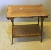 A Victorian walnut two tier side table