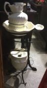 A Continental metal washstand with cream ceramic wash set, chamber bowl, etc.