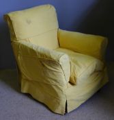 A yellow upholstered armchair