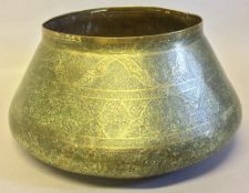 An Islamic brass bowl Extensively worked with arabesques and Islamic text,