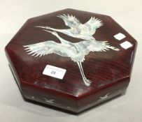 A Chinese mother-of-pearl inlaid lacquered sectional box and cover;