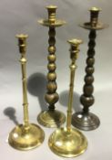 Two large pairs of brass candlesticks