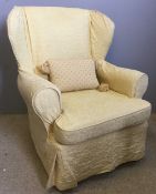 A yellow covered upholstered armchair