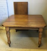 A Victorian walnut extending dining table