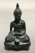 A Chinese antique patinated bronze model of Buddha