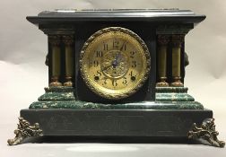 A Victorian faux marble mantle clock