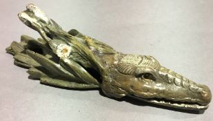 A bronze paper clip in the form of a crocodile