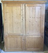 A large Victorian pine four door cupboard