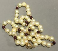 A pearl and garnet necklace