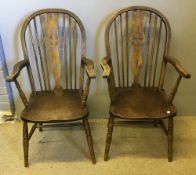 A pair of elm seated wheel back open armchairs