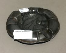 A Continental pewter life ring and fish form ashtray