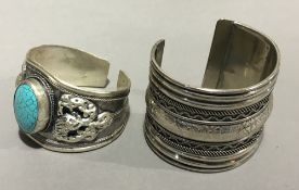 Two white metal bracelets