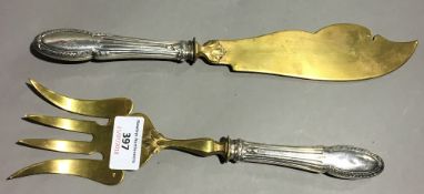 A pair of silver handled servers