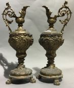 A pair of bronze ewers