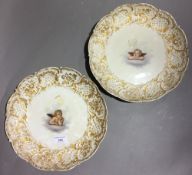 A pair of Meissen porcelain plates each decorated with a cherub