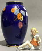A Crown Devon vase and a Continental porcelain figurine