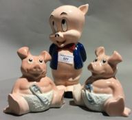 A Looney Tunes Porky Pig money box and two Natwest pigs