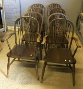 A set of eight wheel back chairs